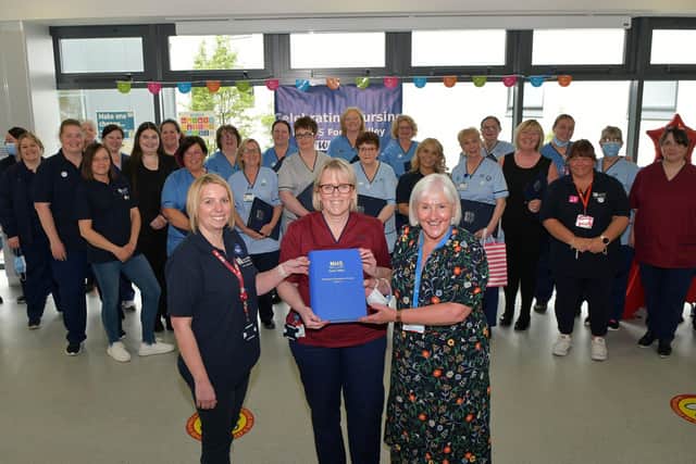 Book of pandemic reflection handed over by Hilary Nelson, nurse and RCN Forth Valley branch representative, left, to Cathie Cowan, Forth Valley NHS chief executive, and Professor Frances Dodd, executive nurse director. Pic: Michael Gillen