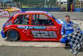 Newly crowned world champion Jason Secker with his winning car and trophy