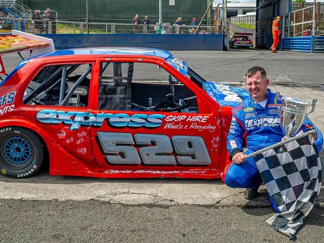 Newly crowned world champion Jason Secker with his winning car and trophy