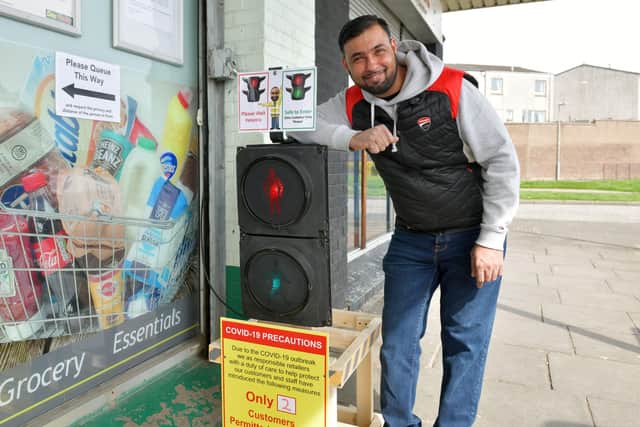 Hallglen Convenience Store owner Shraz Abdul Khaliq with his patented customer traffic light system