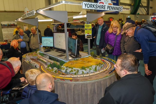 Crowds gather round the many different layouts on display