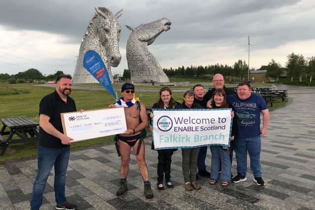Members of the Enable Falkirk branch received a cheque for £2000 from Speedo Mick as the Liverpudlian stopped off at The Kelpies last weekend. Contributed.