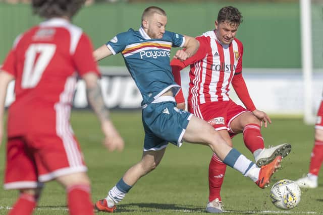 Stuart Anderson battles for the ball with Motherwell's Allan Campbell during Formartine United's 5-0 Scottish Cup third round loss to Motherwell on April 3, 2021 (Pic Dave Cowe)