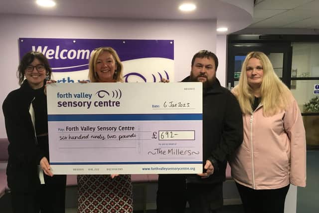 Cash raised for Forth Valley Sensory Centre from Christmas light display in Falkirk garden, left to right, Sara Burns, FVSC’s energy adviser, Jacquie Winning, chief executive of FVSC, Gordon Miller and Pamela Miller