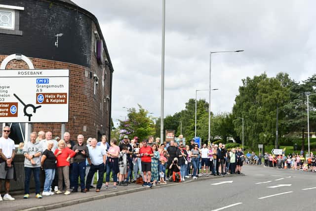 Crowds line the route to cheer on the cyclists, including these people at the Beefeater in Camelon. Pic: Michael Gillen