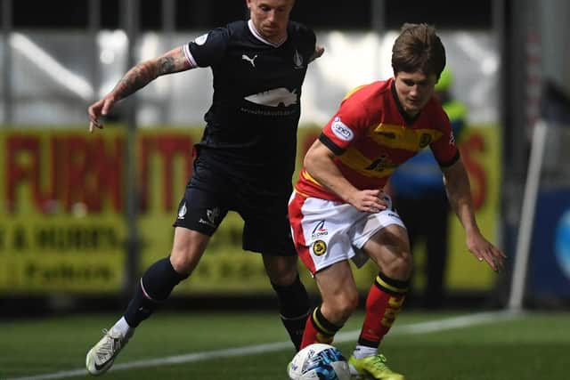 Gary Oliver looks to win the ball from Thistle's Tony Weston