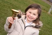 Mila Sneddon, 6, rings the bell as she is in remission from acute lymphoblastic leukaemia