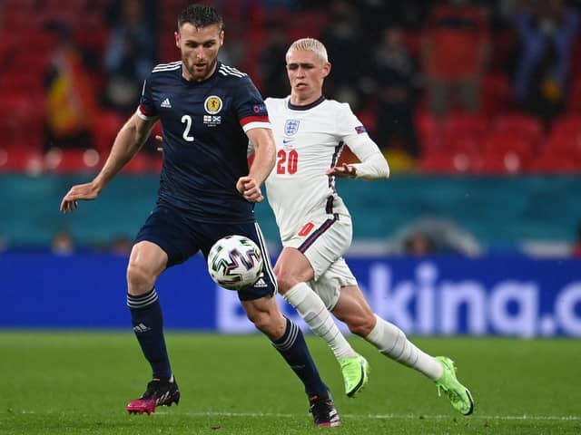 Scotland ace Stephen O'Donnell is pictured with England star Phil Foden during Friday's clash (Pic by Getty Images)