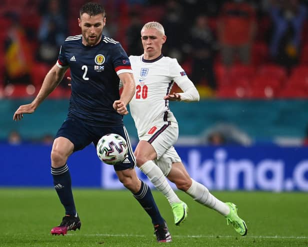 Scotland ace Stephen O'Donnell is pictured with England star Phil Foden during Friday's clash (Pic by Getty Images)