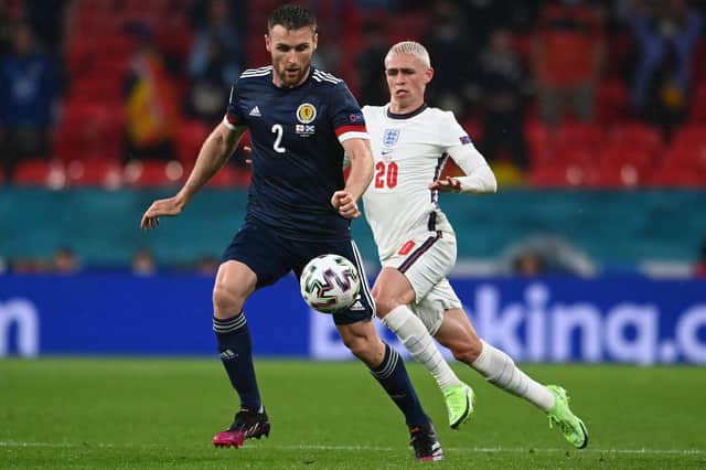 Scotland ace Stephen O'Donnell is pictured with England star Phil Foden during Friday's clash (Pic by Getty Images)