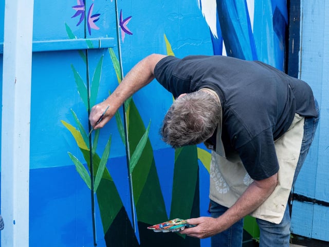 Hard at work on the eye-catching murals.