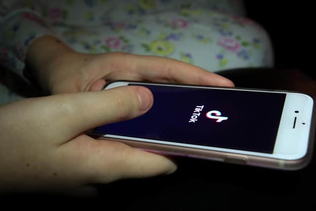 File photo dated 12/11/19 of a young person using the TikTok app on a smartphone, as some young TikTok users are being shown potentially dangerous content which could encourage eating disorders, self-harm and suicide, an online safety group has claimed.