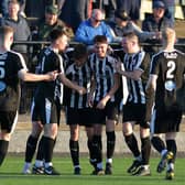 Dunipace's Kai Wilson is mobbed by his teammates after scoring to make it 2-2 at the start of the second half against Linlithgow Rose (Pictures by Michael Gillen)