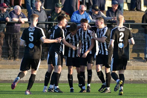 Dunipace's Kai Wilson is mobbed by his teammates after scoring to make it 2-2 at the start of the second half against Linlithgow Rose (Pictures by Michael Gillen)