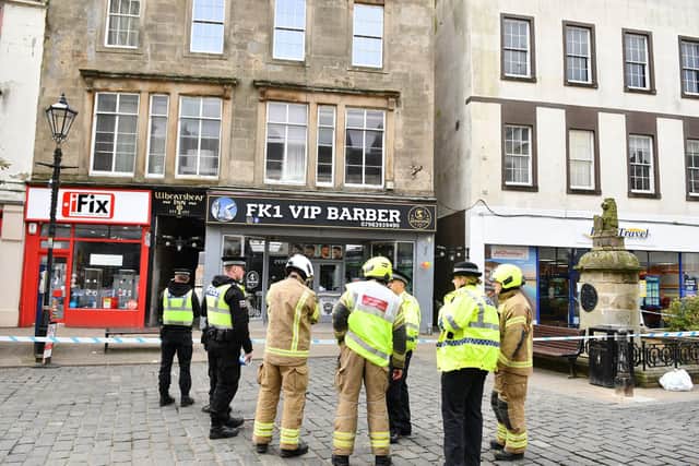 A cordon was put in place on a section of the High Street after masonry fell from one of the buildings hitting a member of the public.  (Pics: Michael Gillen)
