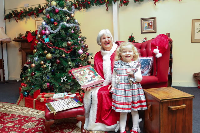Three-year-old Hazel with Mrs Claus.