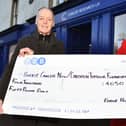 Eddie Hughes, with charity shop volunteer Meg Speedie, raised £4050 in 2023, bringing his fundraising tally in the last 13 years to £65,000. (Pic Michael Gillen)