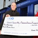 Eddie Hughes, with charity shop volunteer Meg Speedie, raised £4050 in 2023, bringing his fundraising tally in the last 13 years to £65,000. (Pic Michael Gillen)