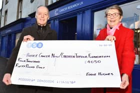 Eddie Hughes, with charity shop volunteer Meg Speedie, raised £4050 in 2023, bringing his fundraising tally in the last 13 years to £65,000. (Pic Michael Gillen)