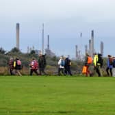 The pilgrimage leaving Bo'ness Foreshore, heading for Grangemouth, with Grangemouth Ineos in the background. Photo: Michael Gillen.