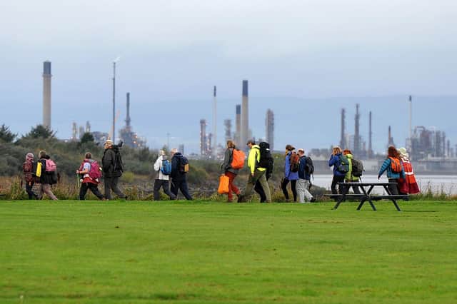 The pilgrimage leaving Bo'ness Foreshore, heading for Grangemouth, with Grangemouth Ineos in the background. Photo: Michael Gillen.