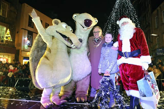 Provost Pat Reid and Darcy Dewar 9 from Avonbridge switch on the Christmas lights with Santa and Ice Age characters Sid and Scrat.