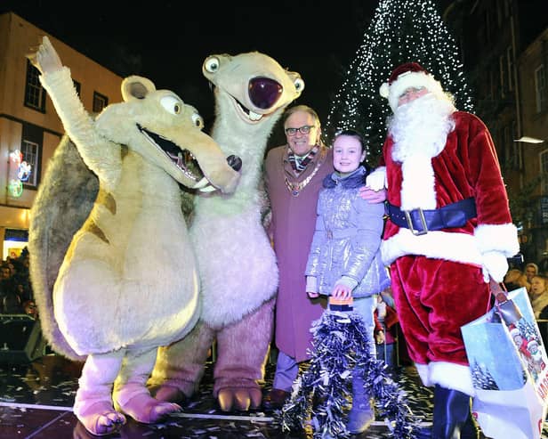 Provost Pat Reid and Darcy Dewar 9 from Avonbridge switch on the Christmas lights with Santa and Ice Age characters Sid and Scrat.