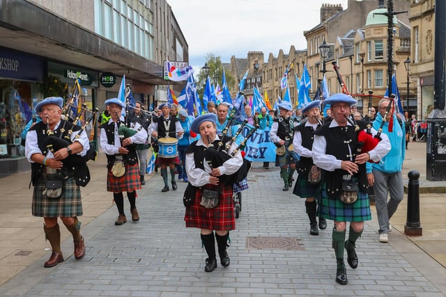 Pipers lead the marchers along Falkirk's High Street.