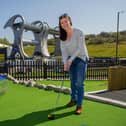 Catherine Topley, CEO at Scottish Canals, tries  out the new crazy golf attraction at The Falkirk Wheel.