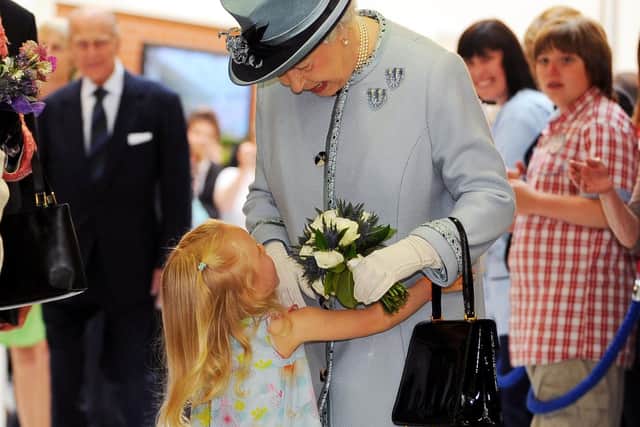 The Queen received a welcoming hug from Hayley Boyle, three, granddaughter of Lord Lieutenant Marjory McLachlan