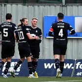Callumn Morrison is mobbed by his Falkirk teammates after scoring the opener against Clyde (Pics by Michael Gillen)