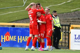 Liam Henderson is mobbed by his Falkirk teammates after scoring against Alloa Athletic (Pictures: Michael Gillen)