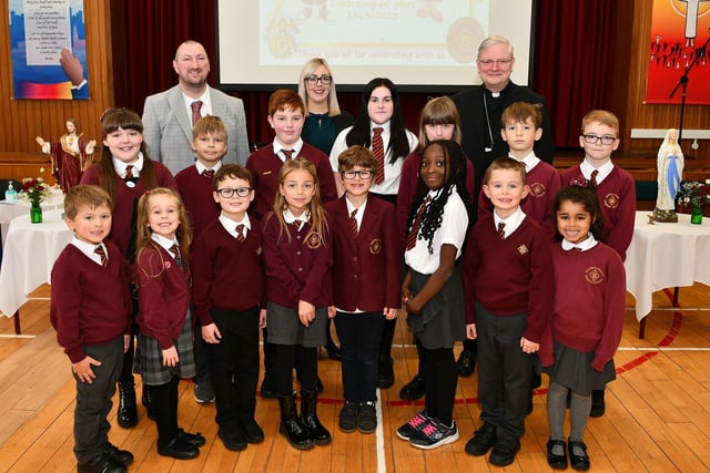 Headteacher Thomas McGovern, depute headteacher Laura Wilson and Archbishop Leo Cushley with some pupils from the school at the 60th anniversary mass.