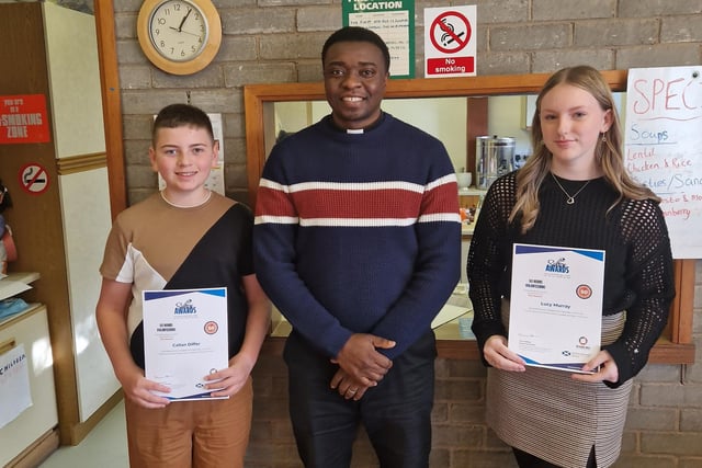 St Mungo's High School pupils Callan Differ and Lucy Murray receive their volunteering awards from Father Benedict Umeohana
(PIcture: Submitted)