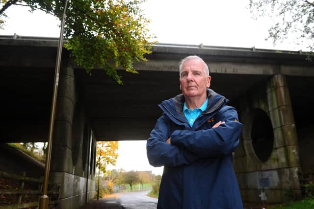 Denny resident Gordon Jack has raised concerns about a danger spot in Castlerankine Road where youths have been climbing up an underpass onto the M80 flyover. Picture: Michael Gillen.