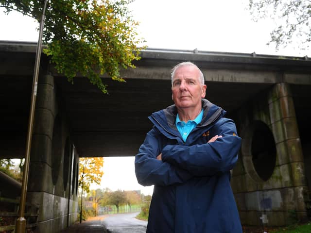 Denny resident Gordon Jack has raised concerns about a danger spot in Castlerankine Road where youths have been climbing up an underpass onto the M80 flyover. Picture: Michael Gillen.