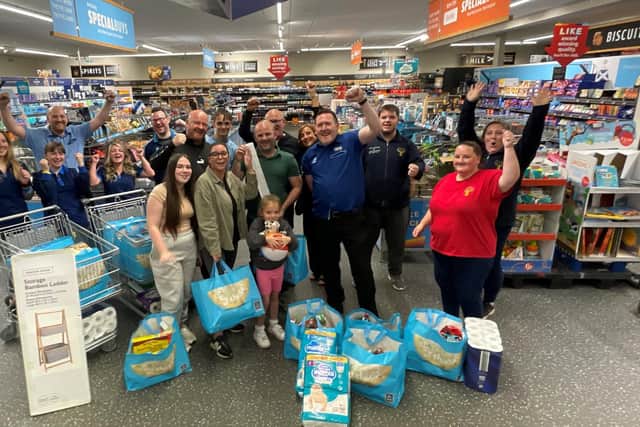 Family, friends and Aldi staff join Mikey to celebrate his big win and prodigious haul 
(Picture: Submitted)