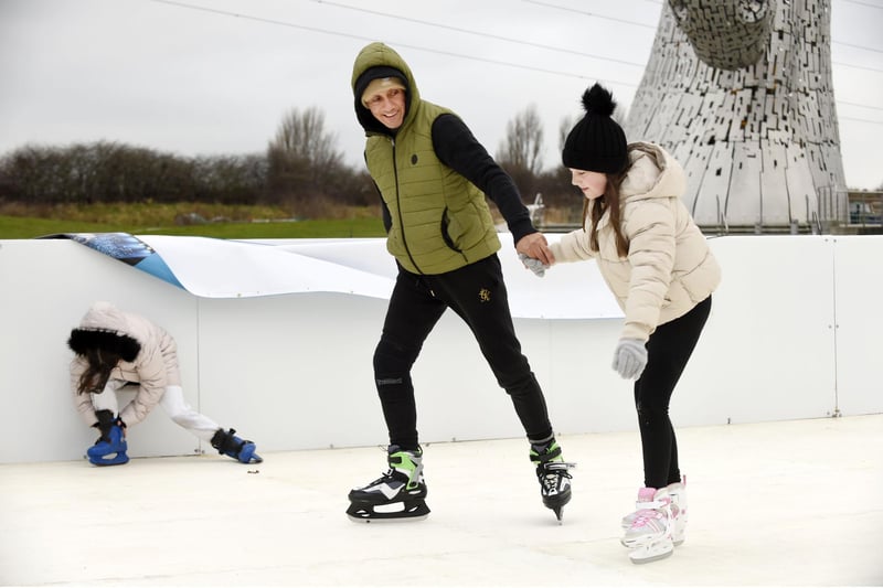 Colin Snow and Sienna McGarry (10) go for a spin on the rink.