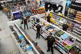 Halfords in Falkirk's Central Retail Park reopened on March 25 after an electrical fire forced it to close for eight months. Manager Greg Dornan (top left) with colleagues. Picture: Michael Gillen.