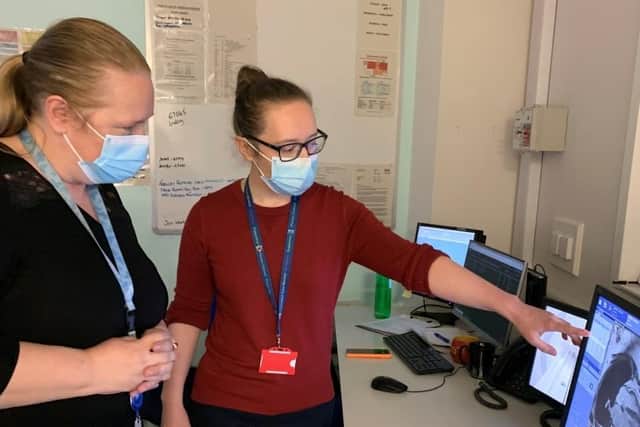 NHS Forth Valley Consultant Radiologist, Dr Lindsey Norton (right) reviews a cardiac MRI scan.