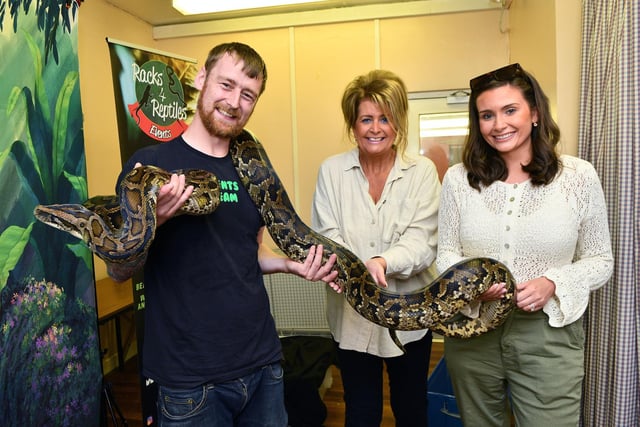 Racks 4 Reptiles' George Struthers and his large silent friend join mum and daughter Yvonne Johnstone and Demi Sneddon at the fun day 
(Picture: Michael Gillen, National World)