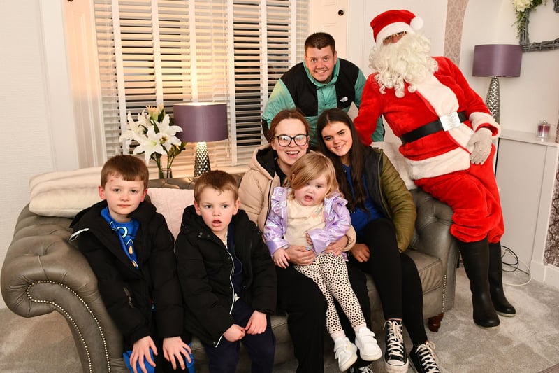 All together now - Arya and her family welcome Father Christmas into their home