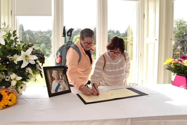 Deb Cayzer, 64, from Western Australia, and sister Jo Cayzer, 59, from Magnetic Island, Australia sign the book of condolence in Callendar House