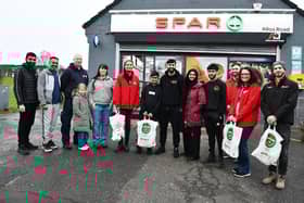 Safebase volunteers collect Christmas Day food parcels from Asiyah Javed, Jawad Javed and family, at their shop in Alloa Road. Pic: Michael Gillen.