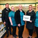 Handing over £800 to Scott Martin Foundation: left, to right, Andrew Merrilees; Krystal Swan, healthcare assistant; Tracey Eddie, checking technician; Samantha Merrilees; Mhairi Neil, dispenser and Stacey Kemp, dispenser. Pic: Michael Gillen