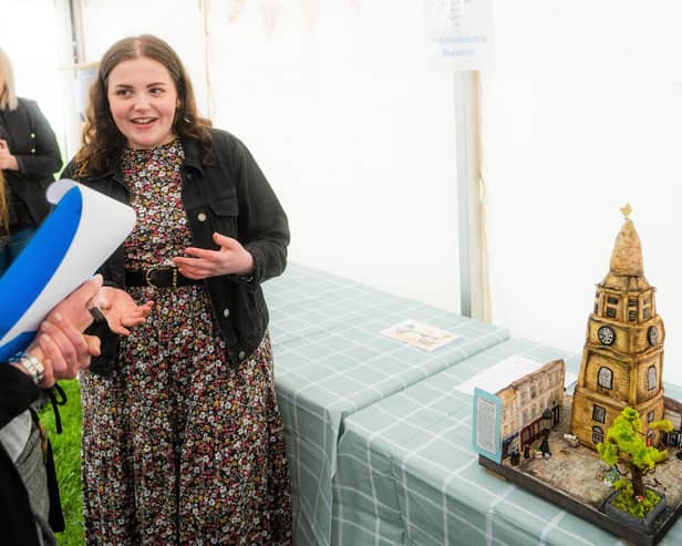 Chloe Edwards and her cake depicting the Steeple and surrounding buildings
