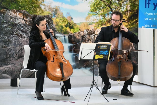 The cellists kept people entertained with their performance.