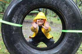 A youngster at Willow Den, at The Falkirk Wheel, celebrates high fives from the Care Inspectorate