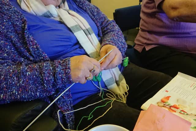 Elizabeth Ann Johnston knits while she attends the crafts and games cafe