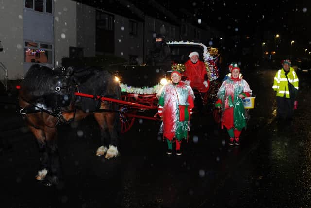 Santa and his helpers took to the streets as part of Camelon Winter Festival to spread Christmas cheer. Picture: Michael Gillen.